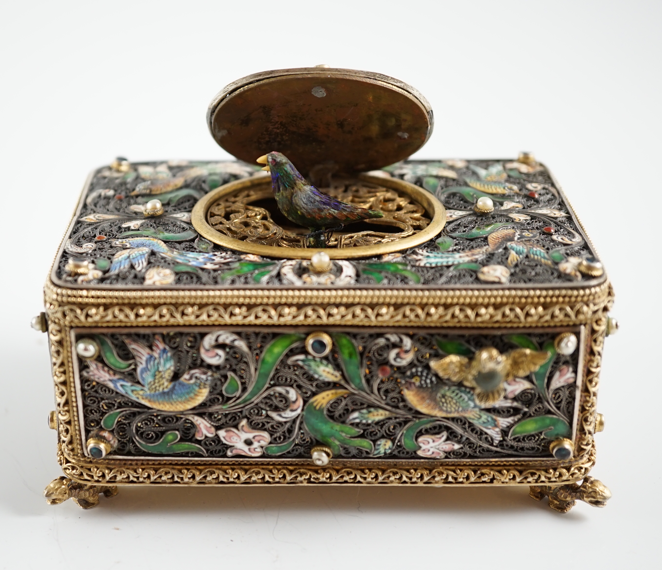 A 19th century Austro-Hungarian 800 standard silver gilt, jewelled and enamelled rectangular singing bird box automaton